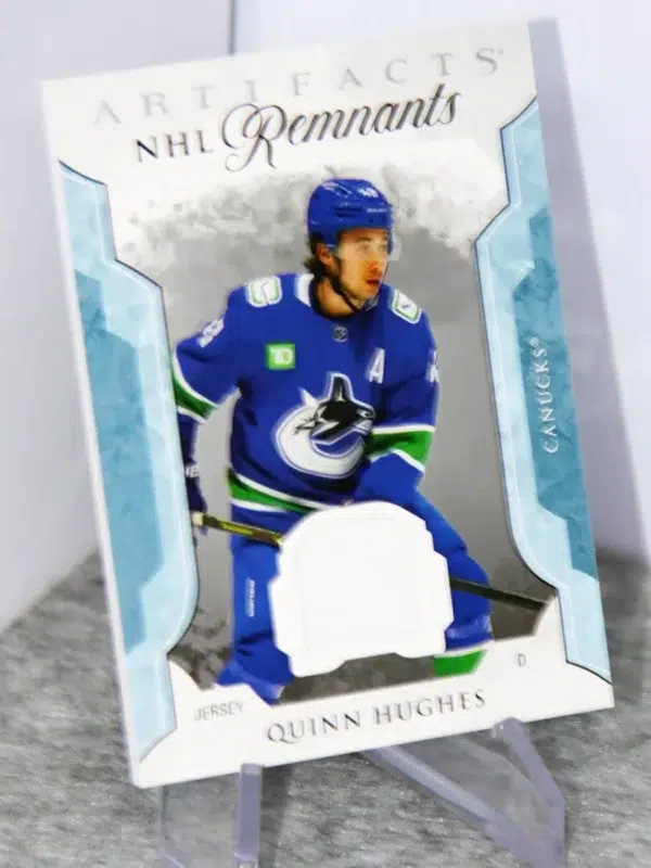 2023-24 Quinn Hughes #NR-QH Upper Deck Artifacts NHL Remnants Jersey Patch - stand